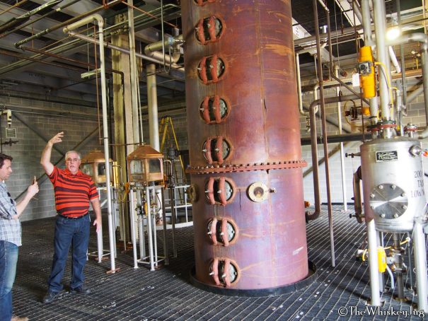 Wild Turkey Distillery: Master Distiller Eddie Russell standing next to their current still which is 60 inces around and 52 feet high with 19 stripping plates.