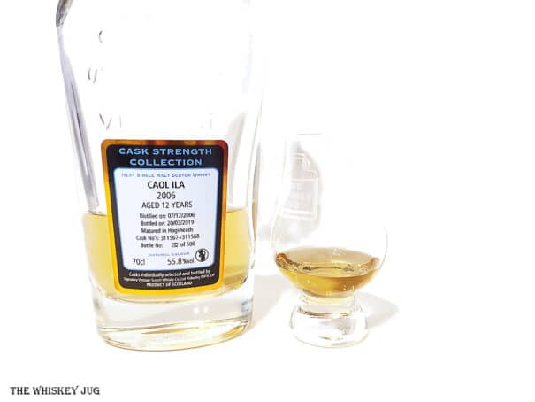 White background tasting shot with the 2006 Signatory Caol Ila 12 bottle and a glass of whiskey next to it.