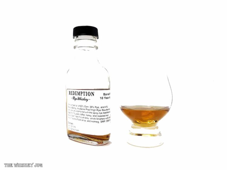 White background tasting shot with the Redemption 10 Year Barrel Proof High Rye Bourbon bottle and a glass of whiskey next to it.