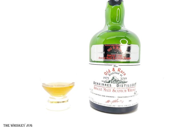 White background tasting shot with the 1979 Old and Rare Benrinnes 40 Years bottle and a glass of whiskey next to it.
