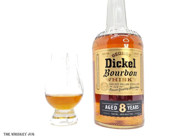 White background tasting shot with the George Dickel Bourbon 8 Years bottle and a glass of whiskey next to it.
